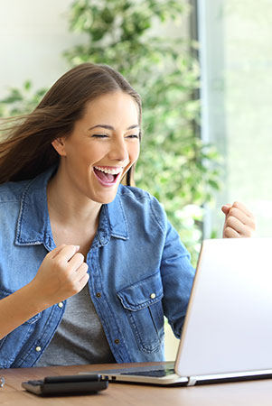 women cheering at laptop