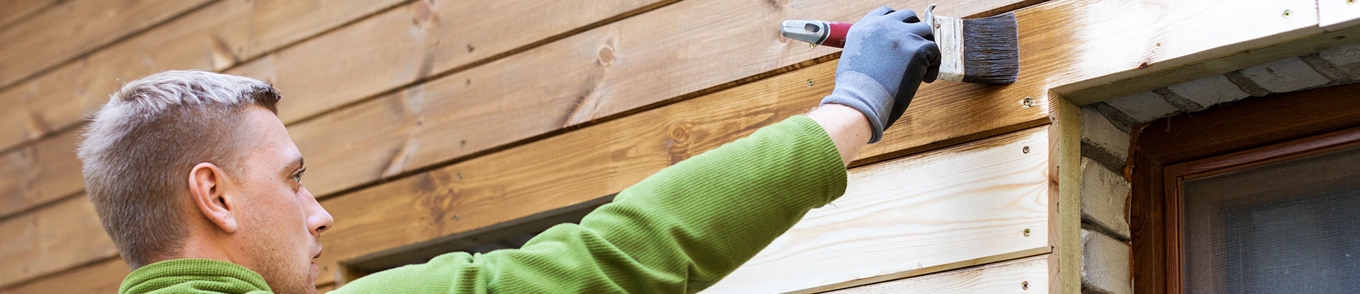 man staining outside of a building